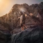 a man standing on top of a rocky mountain