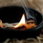 a lit candle with smoke coming out of it